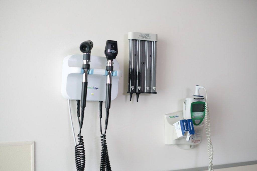 Medical diagnostic tools mounted on a wall in a clinical setting
