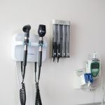 Medical diagnostic tools mounted on a wall in a clinical setting